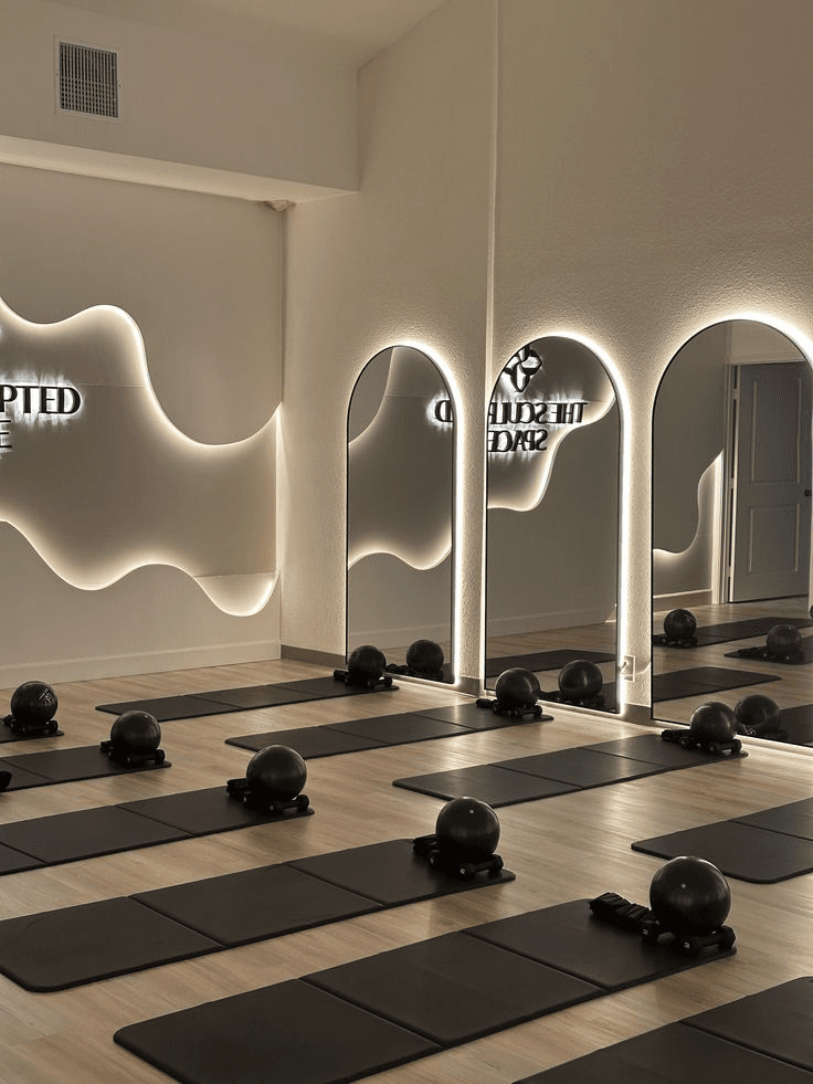 Modern minimalist training studio with arched mirrors