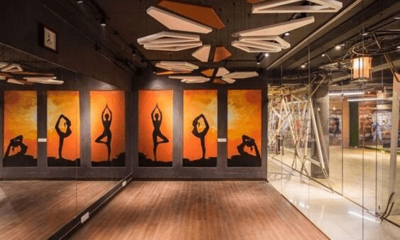 Wellness studio with artistic yoga sunrise murals